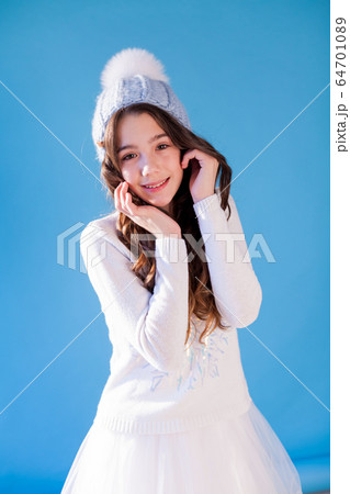 portrait of a beautiful fashionable girl in a winter hat from cold and snow portrait of a beautiful fashionable girl in a winter hat from cold and snow 64701089