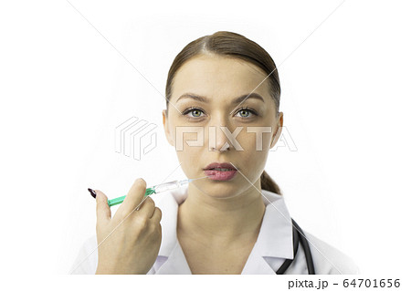 Portrait of beautiful cosmetologist making botox injection procedure in underlip 64701656