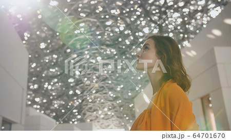 Girl enjoys views of the Louvre Hall in Abu Dhabi. Girl enjoys views of the Louvre Hall in Abu Dhabi. 64701670
