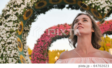 A girl walks through a fabulous park in Dubai. 64702023