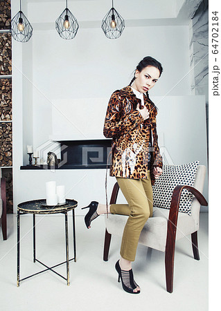 pretty stylish woman in fashion dress with leopard print in luxury house interior, lifestyle people concept 64702184