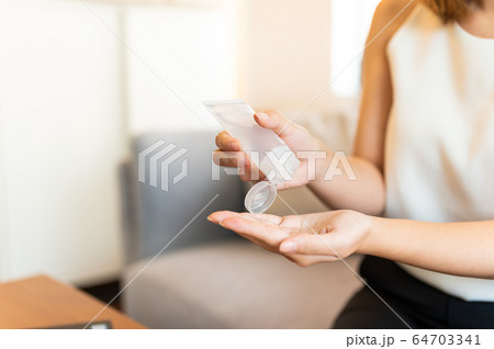 Young asian woman washing hand by sanitizer gel 64703341
