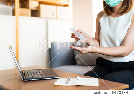 Young asian woman washing hand by sanitizer gel 64703342