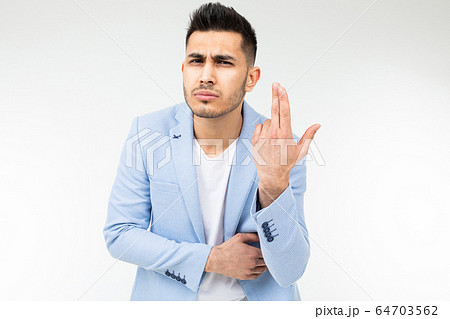 business man in a blue classic jacket pretends to think on a white background with copy space 64703562