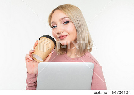 girl on a coffee break with a cup of coffee and a laptop in her hands on a white background girl on a coffee break with a cup of coffee and a laptop in her hands on a white background 64704186