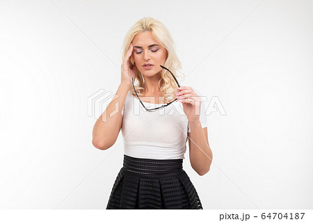 Girl is having a headache and stress while wearing glasses for vision. white background and empty Girl is having a headache and stress while wearing glasses for vision. white background and empty 64704187