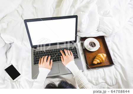 Selective focus,top view woman's hand typing on keyboard,croissant,coffee and mobile phone in white bedroom,work online lifestyle,relax at home Selective focus,top view woman's hand typing on keyboard,croissant,coffee and mobile phone in white bedroom,work online lifestyle,relax at home 64708644
