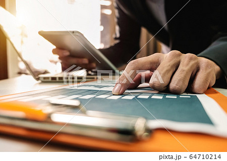 Hands of woman using mobile phone in modern office with laptop and digital tablet at home office Hands of woman using mobile phone in modern office with laptop and digital tablet at home office 64710214