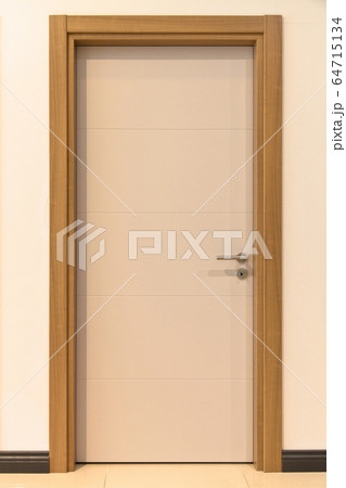 Modern white and brown front wooden door in house 64715134