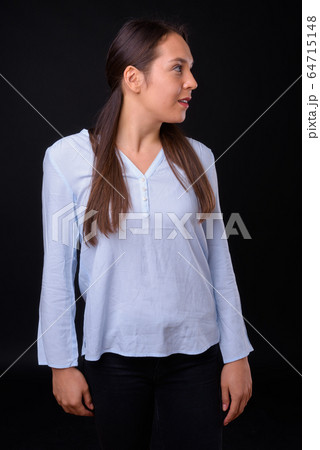 Young multi ethnic beautiful businesswoman against black background Young multi ethnic beautiful businesswoman against black background 64715148