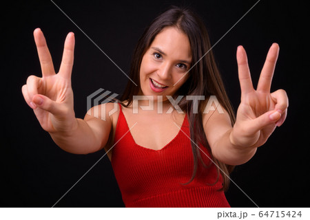 Young multi ethnic beautiful woman against black background Young multi ethnic beautiful woman against black background 64715424