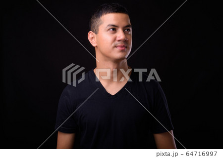 Portrait of young handsome Asian man thinking Portrait of young handsome Asian man thinking 64716997