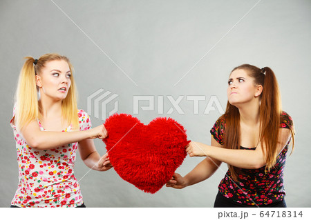 Two agressive women having argue fight holding 64718314
