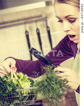 Woman looking through magnifier at vegetables Woman looking through magnifier at vegetables 64718683