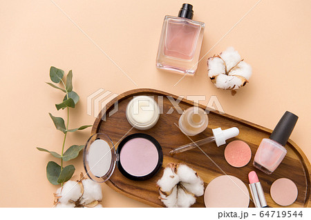 makeup, perfume and cosmetics on wooden tray 64719544