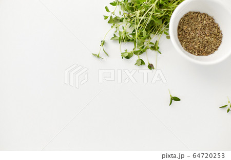 fresh thyme and dry seasoning on white background fresh thyme and dry seasoning on white background 64720253