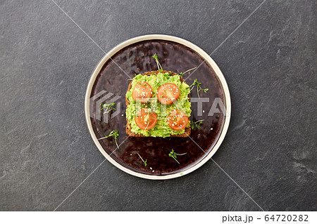 toast bread with mashed avocado and cherry tomato toast bread with mashed avocado and cherry tomato 64720282