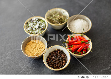 bowls with different spices on slate stone table bowls with different spices on slate stone table 64720662