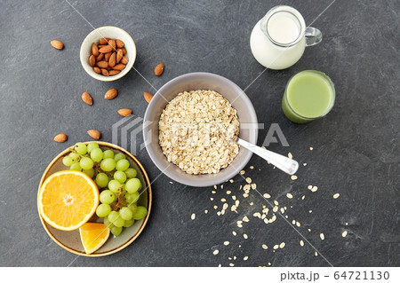 oatmeal with fruits, almond nuts and jug of milk oatmeal with fruits, almond nuts and jug of milk 64721130