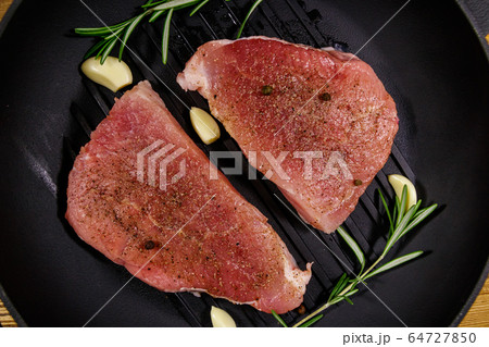 Raw pork steaks ready for preparation  64727850