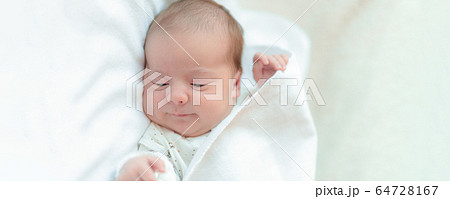 infancy, childhood, family, care, medicine, sleep, health concept - extra wide banner portrait of newborn baby wrapped in diaper on white background, copy spase, mock up, close-up, crop, soft focus. infancy, childhood, family, care, medicine, sleep, health concept - extra wide banner portrait of newborn baby wrapped in diaper on white background, copy spase, mock up, close-up, crop, soft focus. 64728167