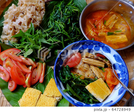 tray of food for vegetarian breakfast, homemade Vietnamese dry pancake noodles soup 64728949