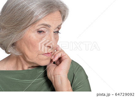 Close up portrait of sad senior woman on white background Close up portrait of sad senior woman on white background 64729092