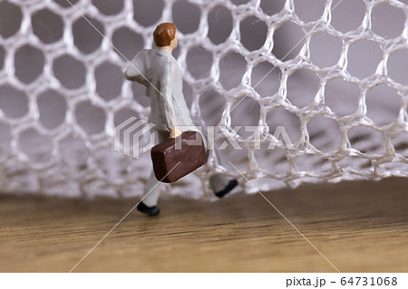 網の目を抜けようとするビジネスマン 64731068