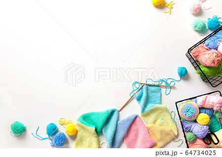 Women crochet and knitting from colored yarn. Top view. 64734025