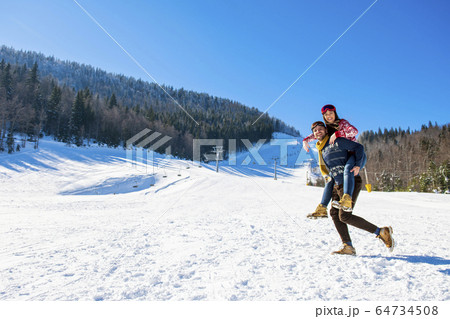 happy couple having fun over winter background 64734508