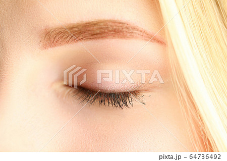 Closed eye of beautiful blonde woman in morning sunshine 64736492