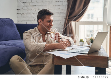 Man under quarantine drinking a healthy beverage Man under quarantine drinking a healthy beverage 64738855
