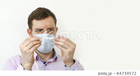 Coronavirus. Quarantine. A man in a shirt measures Coronavirus. Quarantine. A man in a shirt measures 64739572