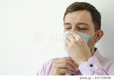 Coronavirus. Quarantine. A man in a shirt puts on Coronavirus. Quarantine. A man in a shirt puts on 64739696