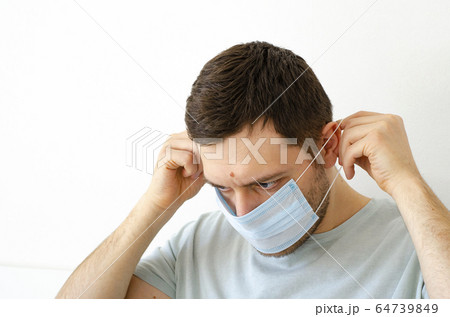 Coronavirus. Quarantine. A man puts on a mask. Coronavirus. Quarantine. A man puts on a mask. 64739849