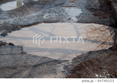 Dangerous destroyed roadbed. Bad asphalted road. 64740153