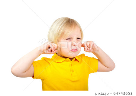 Annoyed boy covers his ears with fingers Annoyed boy covers his ears with fingers 64743653