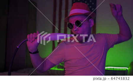 Smoker Of Hookah Dancing In Neon Lights At Home 64743832