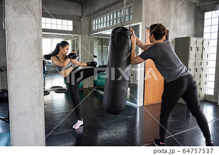 Thai boxing practice with coach in gym 64757537