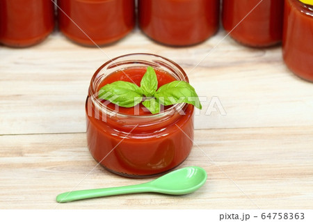 Homemade preserved ketchup and basil leaves Homemade preserved ketchup and basil leaves 64758363