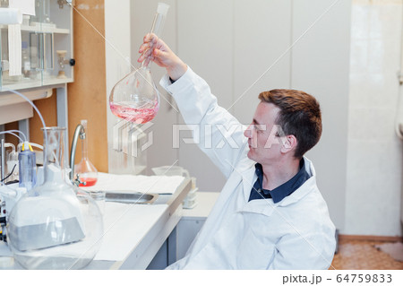 male scientist conducts chemical experiments in medical science laboratory 64759833