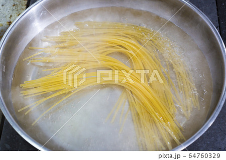Cooking pasta in a pan. Close-up shot in the kitchen. Cooking pasta in a pan. Close-up shot in the kitchen. 64760329
