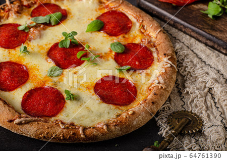 Homemade salami pizza with cheese corners Homemade salami pizza with cheese corners 64761390