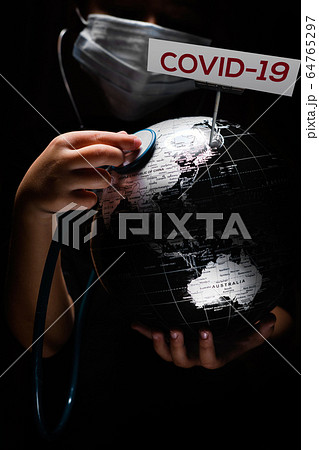 Hands of kid holding globe COVID-19 sign Hands of kid holding globe COVID-19 sign 64765297