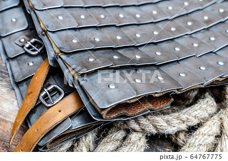 armor with iron plates and leather belts close-up 64767775