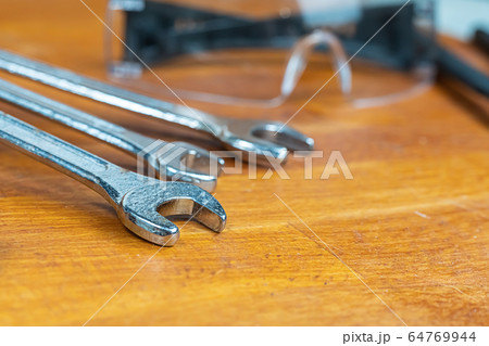set of iron wrenches lie on a blurred background set of iron wrenches lie on a blurred background 64769944