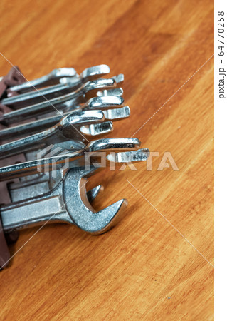 heap of iron and silver wrenches close-up on a 64770258