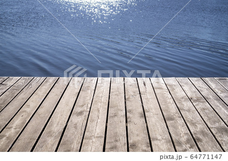 Wooden textured boards of a jetty and reflection 64771147