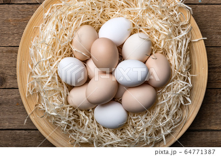 Organic chicken eggs in nest closeup Organic chicken eggs in nest closeup 64771387