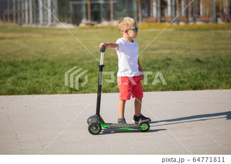 Handsome little boy in stylish sunglasses Handsome little boy in stylish sunglasses 64771811
